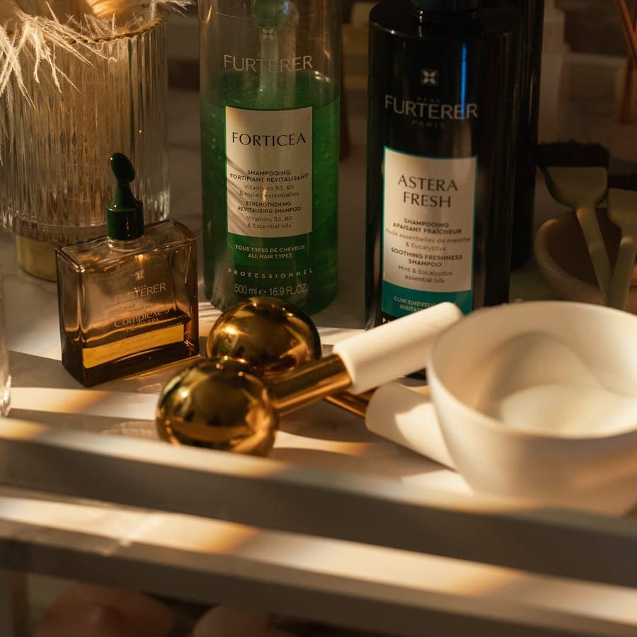 René Furterer scalp and hair products with brass tools on the retail shelf.