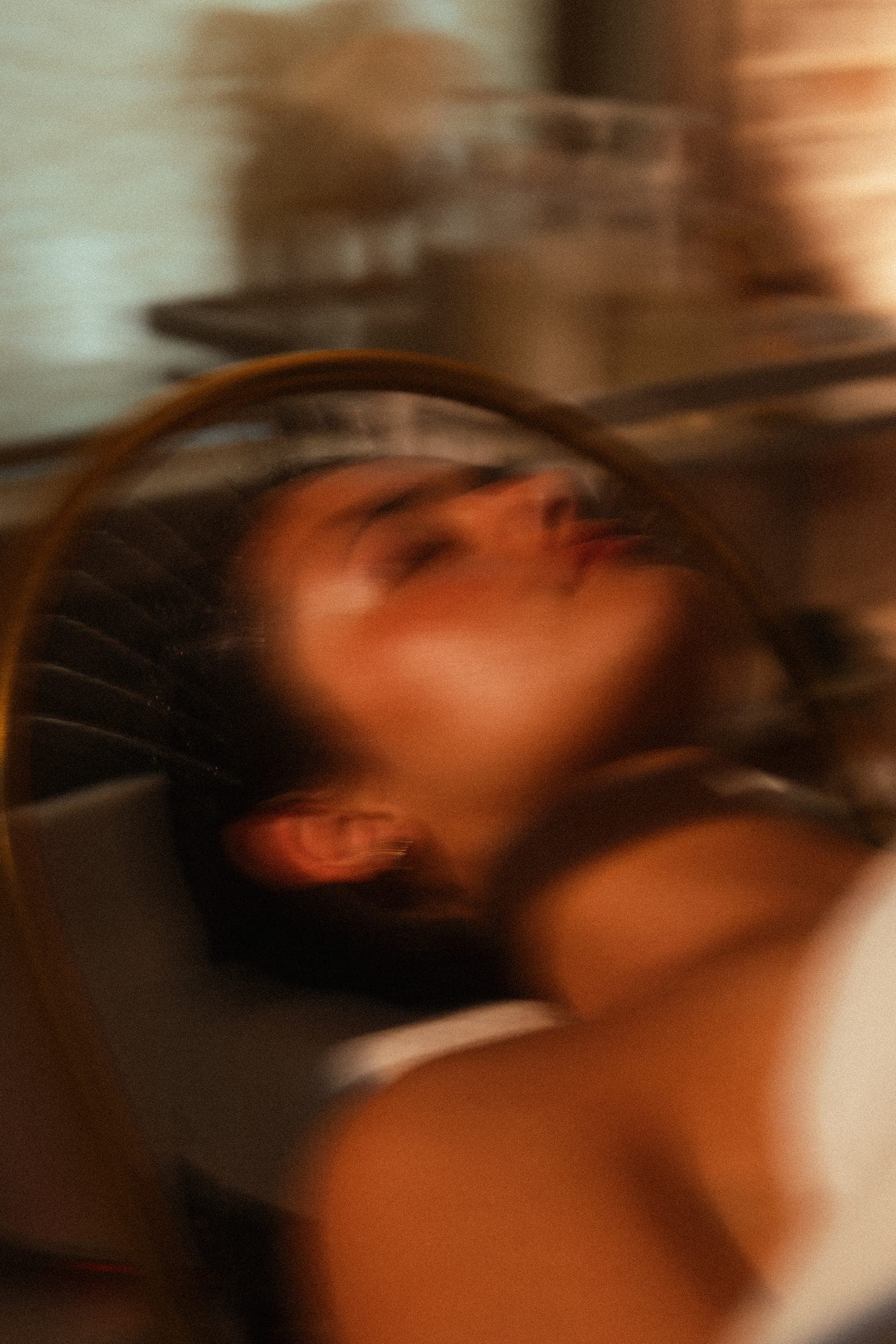 A guest reflected in motion — a long exposure through the salon mirror.