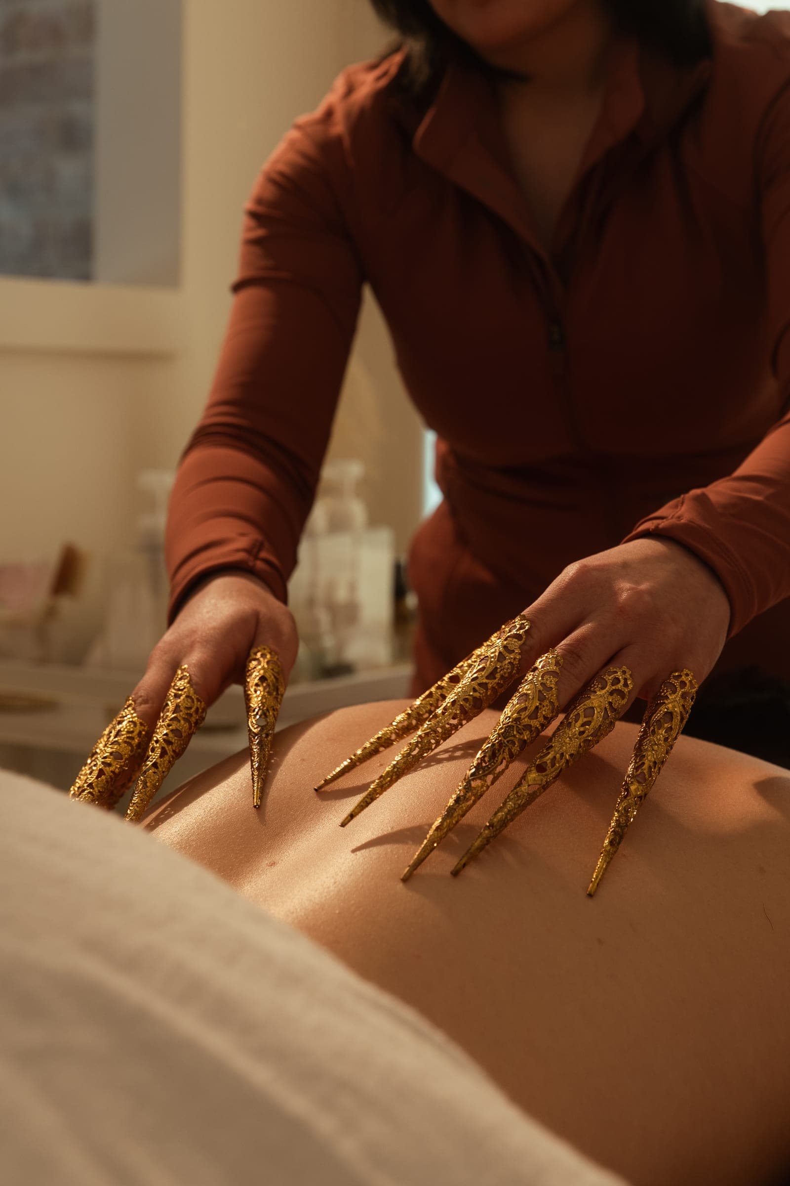 Brass scratch therapy claws drawn across a guest's back.